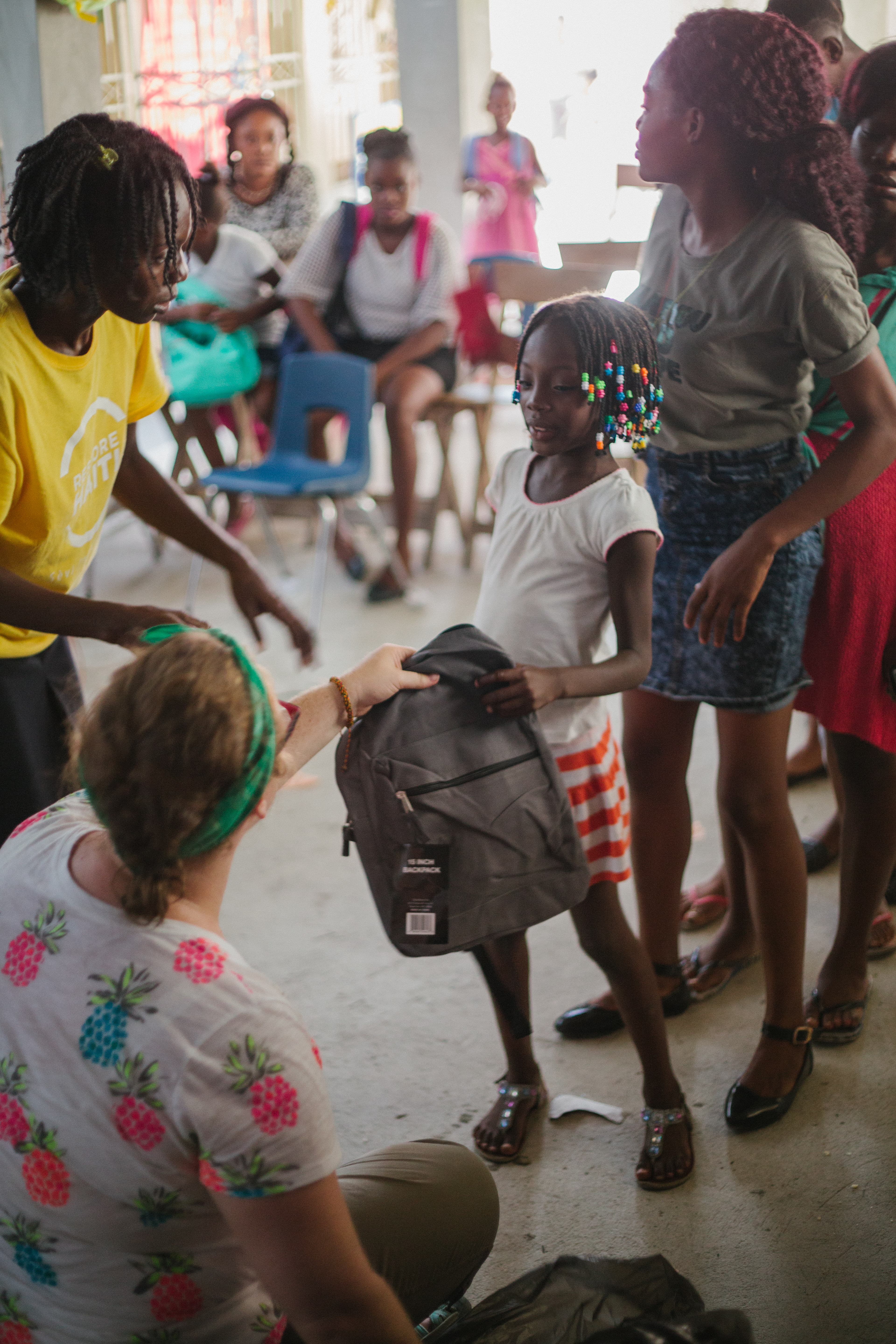 Restore Haiti volunteers distributing school supplies in Carrefour